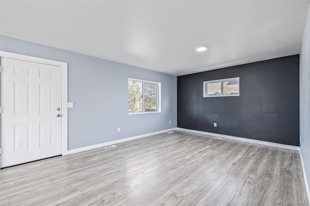 unfurnished room with light hardwood / wood-style floors