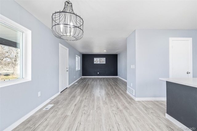 interior space with an inviting chandelier and light wood-type flooring