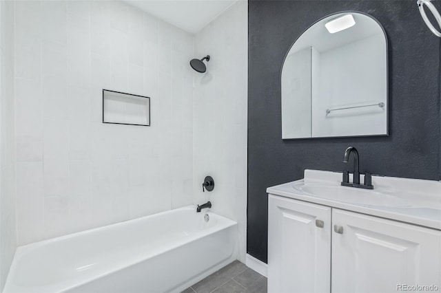 bathroom featuring tiled shower / bath, vanity, and tile patterned floors