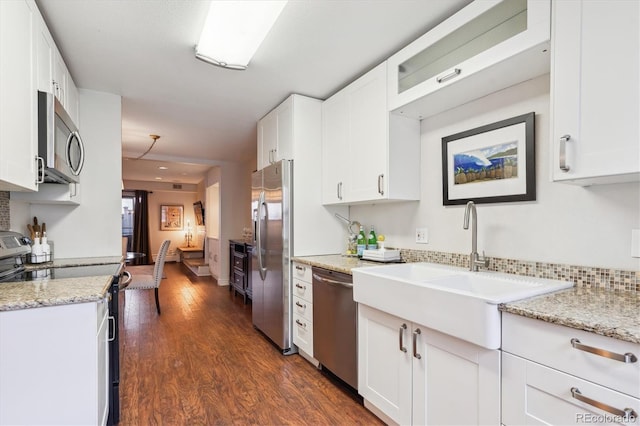 kitchen featuring dark wood-type flooring, stainless steel appliances, sink, and white cabinets