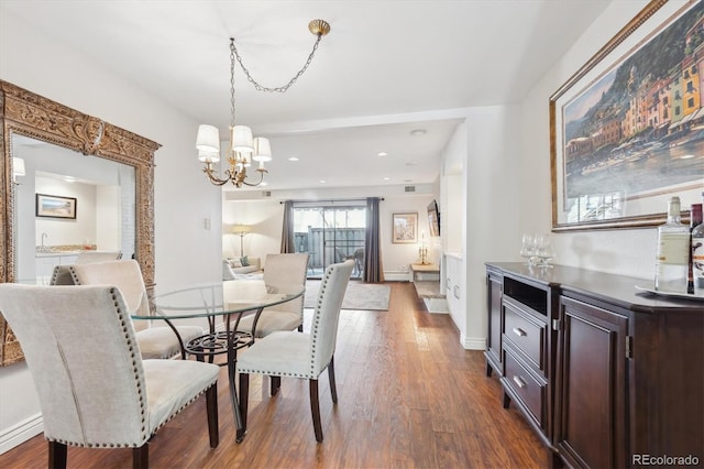 dining area featuring dark hardwood / wood-style floors and a notable chandelier