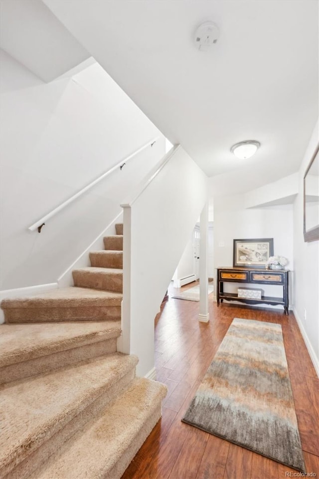 stairs featuring hardwood / wood-style flooring