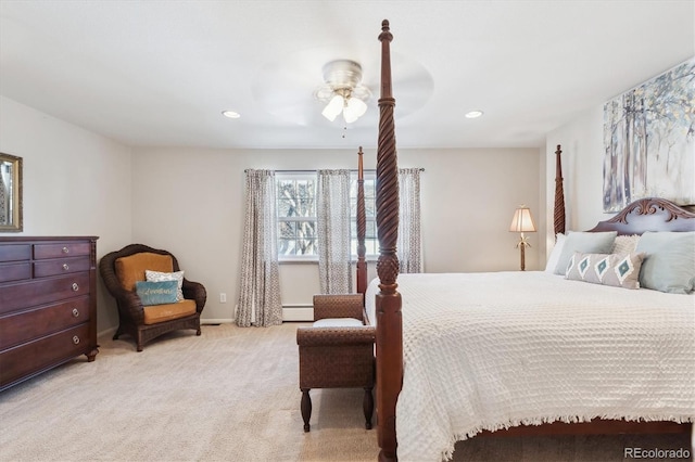 carpeted bedroom with a baseboard heating unit and ceiling fan