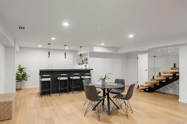 1518 S Columbine St, Denver, CO 80210 - dining area featuring bar area, light wood-type flooring, recessed lighting, baseboards, and stairway