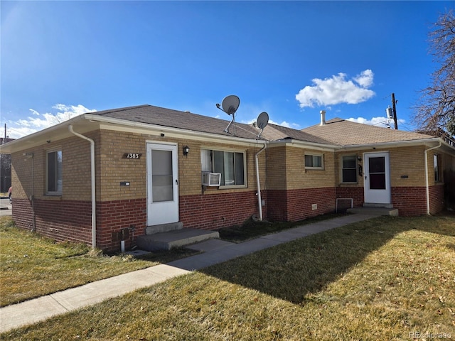 view of front of home featuring a front yard, brick siding, and entry steps