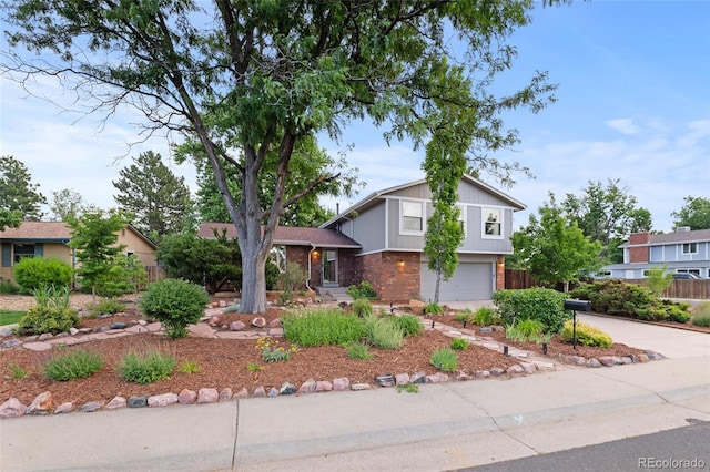 3458 S Norfolk Way, Aurora, CO 80013 - tri-level home featuring brick siding, an attached garage, and concrete driveway