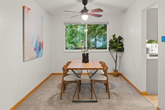 3458 S Norfolk Way, Aurora, CO 80013 - dining area featuring a ceiling fan and light carpet