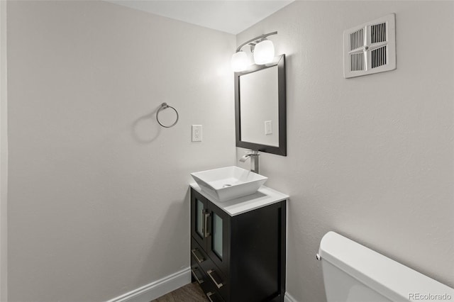 3458 S Norfolk Way, Aurora, CO 80013 - half bath featuring vanity and wood finished floors