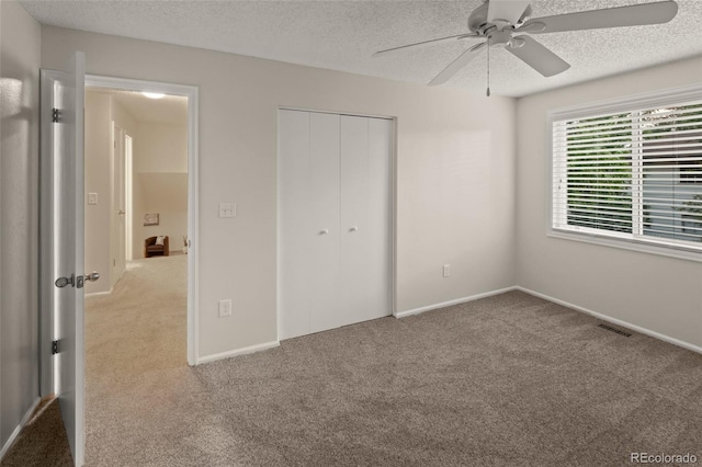 3458 S Norfolk Way, Aurora, CO 80013 - unfurnished bedroom with carpet flooring, a textured ceiling, a closet, and ceiling fan