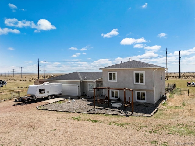 7601 Ronan Ct, Fountain, CO 80817 - rear view of house featuring stucco siding, fence, driveway, and a garage