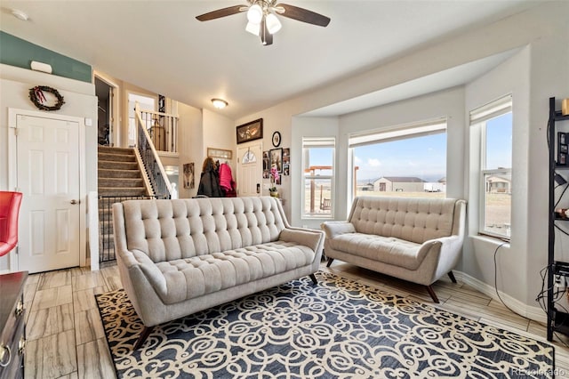 7601 Ronan Ct, Fountain, CO 80817 - living room with ceiling fan, vaulted ceiling, stairs, and a wealth of natural light