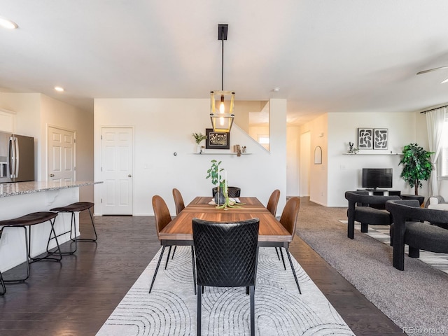 dining space with dark hardwood / wood-style floors