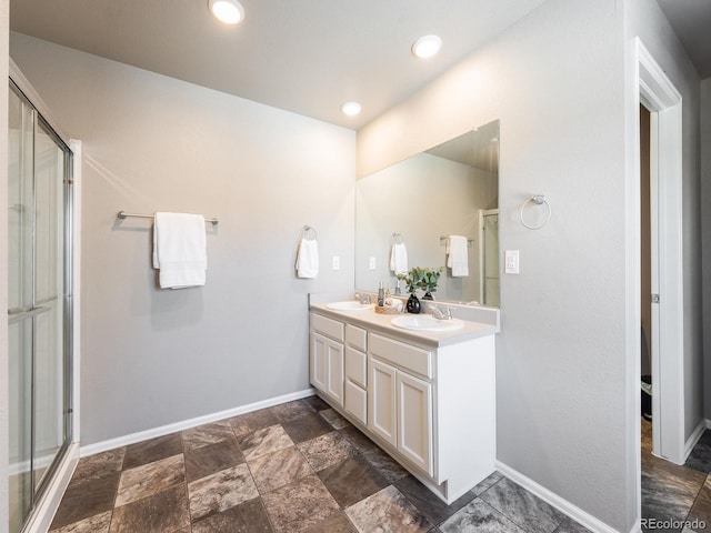 bathroom featuring an enclosed shower and vanity