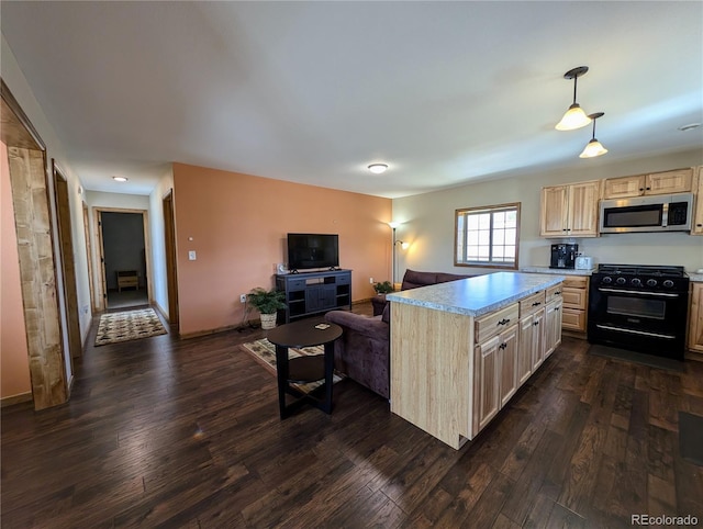 kitchen featuring hanging light fixtures, black stove, and dark hardwood / wood-style floors