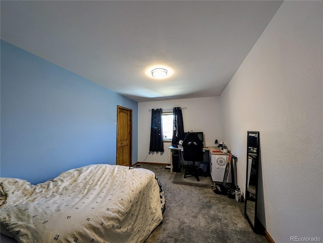 bedroom featuring a textured ceiling and carpet