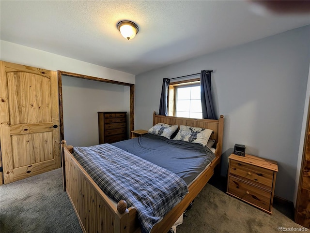 carpeted bedroom featuring a textured ceiling