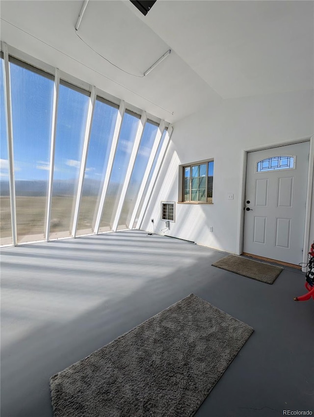 foyer entrance with a healthy amount of sunlight and concrete flooring