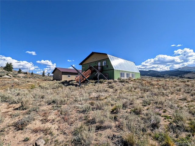 rear view of property featuring a mountain view