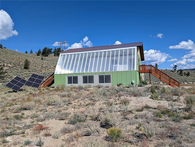 back of property featuring solar panels