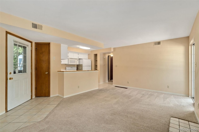 unfurnished living room with light carpet