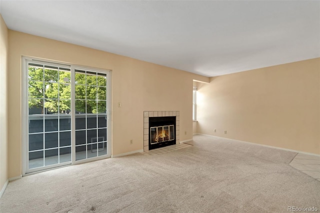 unfurnished living room featuring light carpet and a fireplace