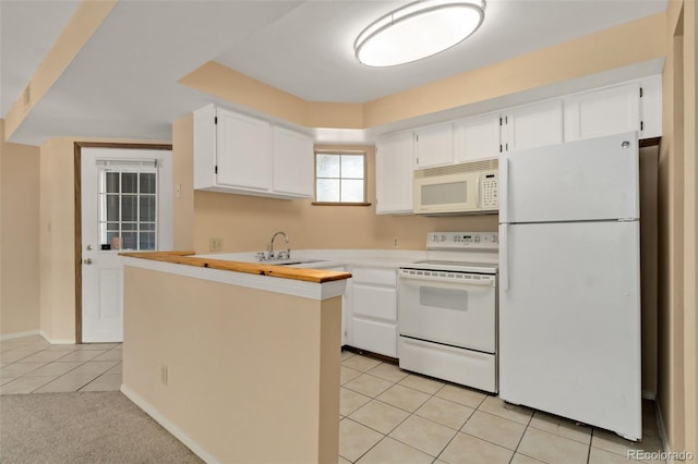 kitchen with white cabinetry, white appliances, sink, and light tile patterned floors