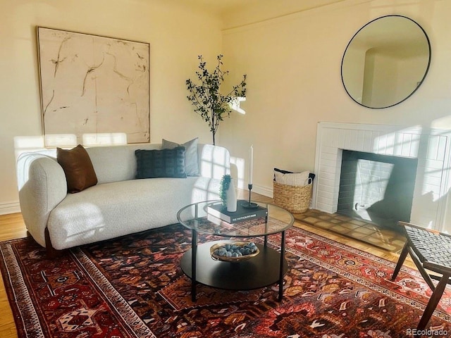 living room with hardwood / wood-style flooring and a fireplace