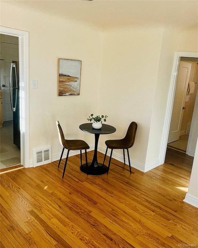 dining area with light hardwood / wood-style floors