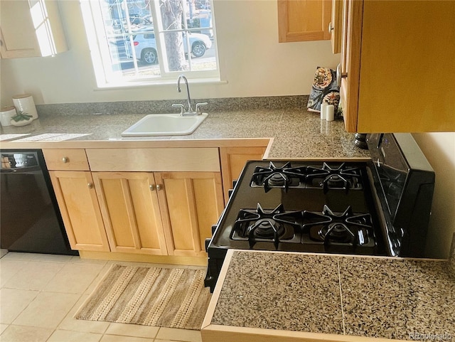 kitchen with light tile patterned flooring, black dishwasher, range with gas cooktop, and sink