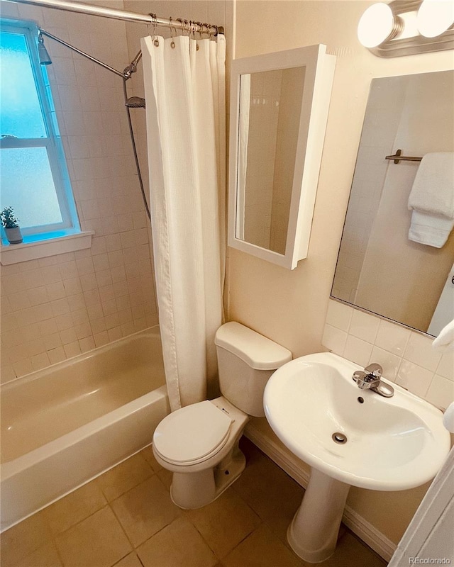 full bathroom featuring sink, toilet, shower / tub combo, and tile patterned flooring