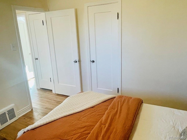 bedroom with a closet and light hardwood / wood-style floors