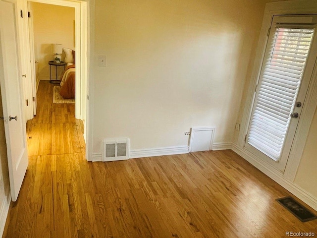 unfurnished room with light wood-type flooring