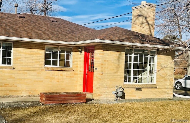 rear view of property featuring a lawn