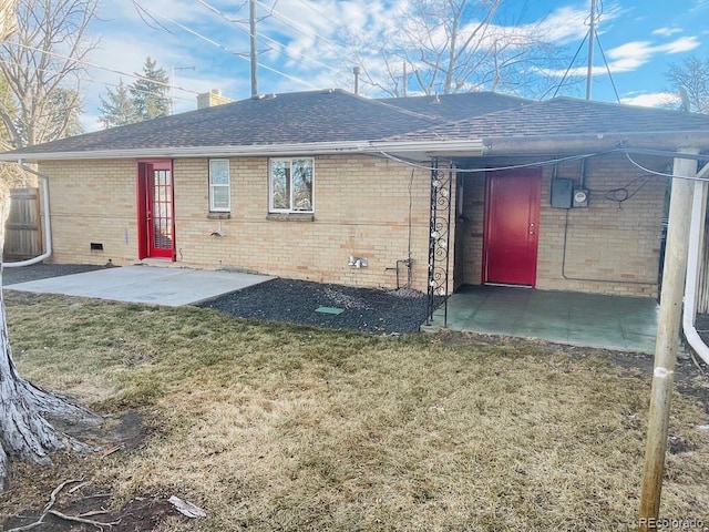 rear view of property featuring a yard and a patio