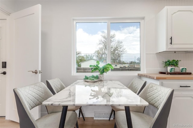 dining space featuring light wood-style floors and breakfast area