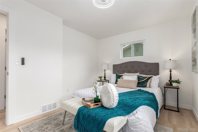 bedroom featuring wood finished floors and baseboards