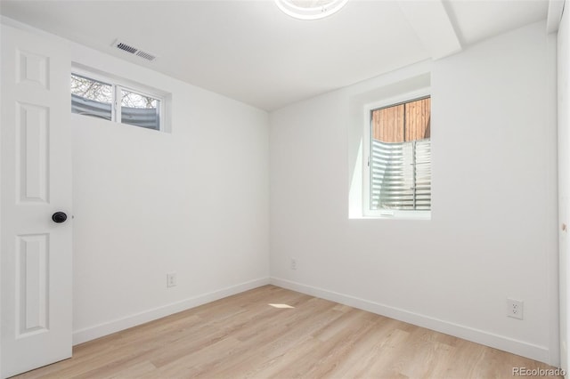 empty room with light wood-style flooring and baseboards
