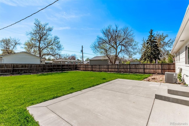 view of yard with central AC unit and a patio area
