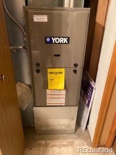 utility room featuring heating unit