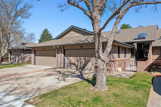 2010 46th Ave Unit 20, Greeley, CO 80634 - ranch-style house featuring brick siding, a garage, driveway, a shingled roof, and a front lawn
