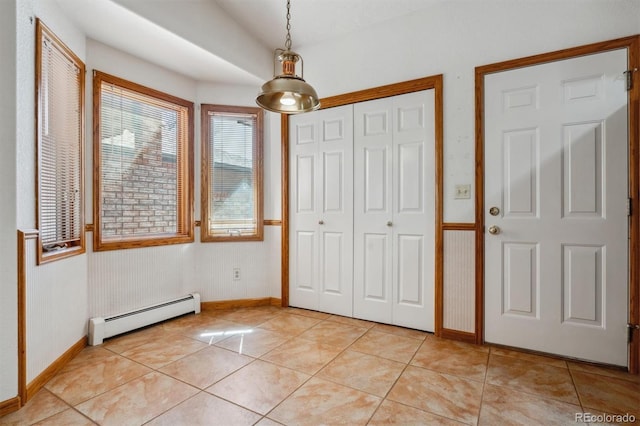 2010 46th Ave Unit 20, Greeley, CO 80634 - unfurnished bedroom featuring a baseboard heating unit, baseboards, a closet, and light tile patterned flooring