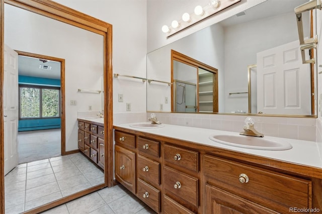 2010 46th Ave Unit 20, Greeley, CO 80634 - bathroom featuring double vanity, tile patterned floors, and a baseboard heating unit