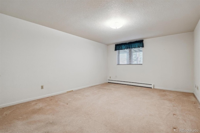 2010 46th Ave Unit 20, Greeley, CO 80634 - carpeted spare room with a baseboard radiator, a textured ceiling, and baseboards