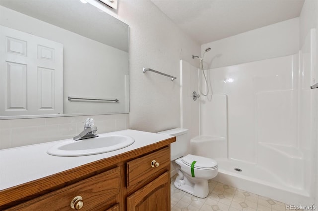 2010 46th Ave Unit 20, Greeley, CO 80634 - bathroom with toilet, vanity, decorative backsplash, a shower, and tile patterned flooring