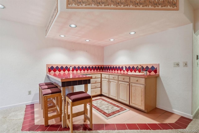 2010 46th Ave Unit 20, Greeley, CO 80634 - bar area with recessed lighting, a sink, light tile patterned floors, and baseboards