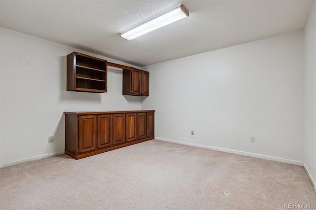 2010 46th Ave Unit 20, Greeley, CO 80634 - spare room with light carpet, a textured ceiling, and baseboards
