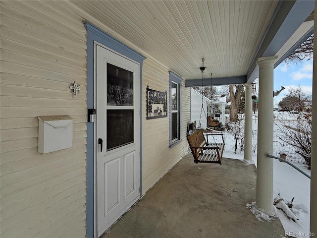 snow covered patio with covered porch