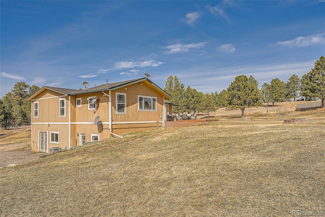 view of home's exterior with a yard and cooling unit