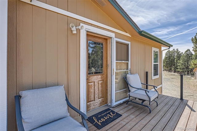 view of exterior entry with a wooden deck