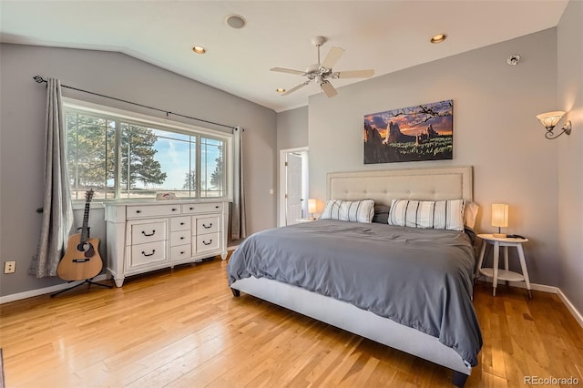 bedroom featuring baseboards, light wood-style floors, ceiling fan, and vaulted ceiling